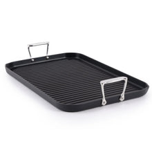 Black ribbed nonstick grill griddle, angled view, with one raised handle on each side