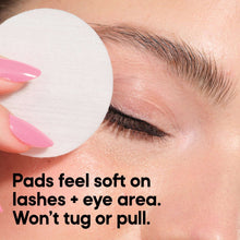 Eye makeup remover pad on eyelid with eyelashes visible, soft circular pad