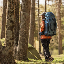 Women’s hiking backpack worn with rain cover and padded shoulder straps
