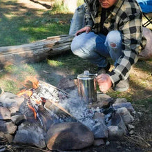 Stainless steel coffee kettle and mugs set used for campfire brewing