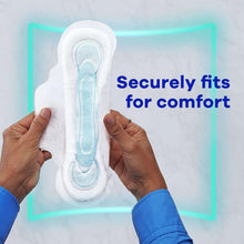 Maxi overnight pad with wings, held between hands showing flexible contoured fit