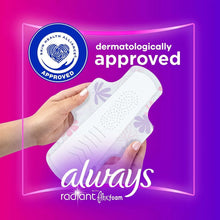 Regular sanitary pad held, white absorbent area with dermatology approval badge