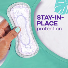 Stay-in-place panty liner on teal underwear, white with blue pattern