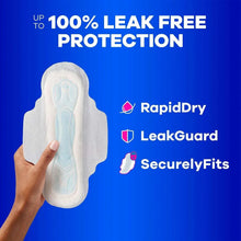 Hand holding a white long pad with a centered blue absorbent strip