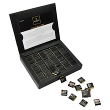 Dark chocolate assortment in open black display box with small wrapped bars