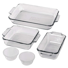 Clear glass baking dish set with three rectangular dishes and four small ramekins