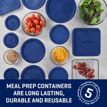 Clear glass food containers with blue lids, top view with bowls and produce