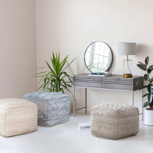 Woven diamond pouf with blue and white pattern, rounded cube shape