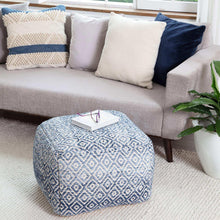 Blue and white diamond-pattern woven pouf on living room carpet