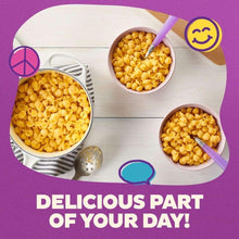 Three bowls of dry pasta shells on a tray with a purple spoon