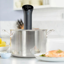 Anova precision sous vide cooker in a stainless steel pot with food