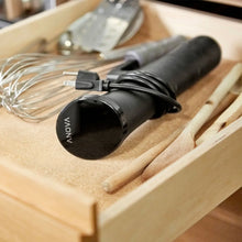 Anova sous vide cooker base with power cord on a wooden tray
