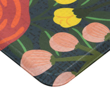 Corner detail of kitchen runner rug with dark backing and multicolor flower print.