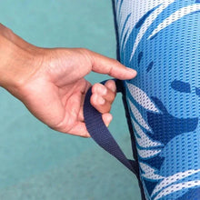Pool lounger strap detail with navy woven webbing and tropical fabric edge