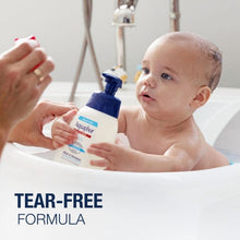 Baby in bathtub with wash & shampoo bottle, tear-free formula