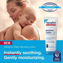 Aquaphor Baby Sensitive Lotion tube held near a newborn and caregiver