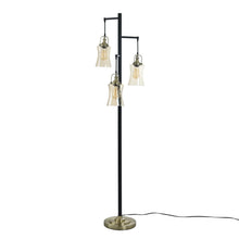 3-light floor lamp with black pole, brass arms, and three clear glass shades