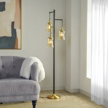Arden 3-light floor lamp with black pole, brass base, clear glass shades