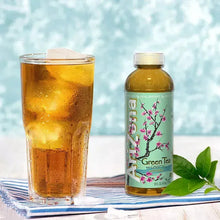 Iced green tea in a glass with a green tea bottle and floral label