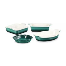 Four-piece stoneware bakeware set with 4 green dishes and white interiors