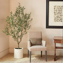 Artificial olive tree with white planter, leafy green branches and trunk