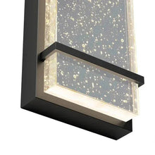 Black wall sconce with speckled bubble glass and projecting dark trim