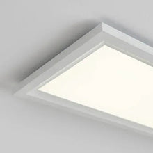 Corner view of flat panel LED ceiling light with white diffuser and light trim