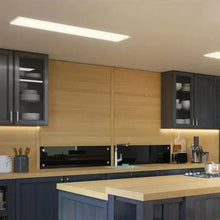 Ceiling-mounted flat panel LED light with white diffuser and silver frame