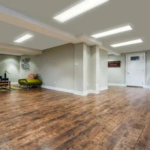 Ceiling-mounted flat panel LED light with white diffuser on a low-profile fixture