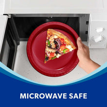 Red paper plate with pizza slice inside microwave