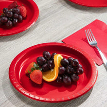 Red paper plate with fruit and grape toppings