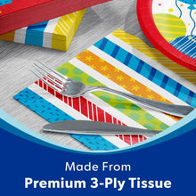 Colorful striped paper napkins with a red party paper plate and fork setting