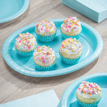 Light blue oval paper plates with 5 frosted cupcakes on top