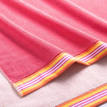 Pink towel with multicolor striped border and soft terry texture