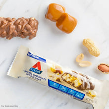 Caramel chocolate nut roll snack bar wrapper with caramel and chocolate pieces