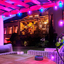 Outdoor pergola string lights with multicolor bulbs along the ceiling