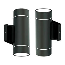 Two black cylindrical outdoor wall sconces with white glow rings