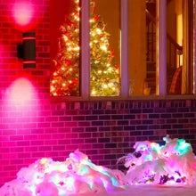 Black outdoor wall sconce with colorful accent lighting on brick wall