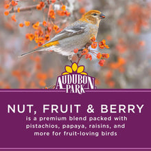 Nut, fruit & berry bird food with perched bird on branch beside brand logo