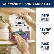 Freeze-dried whole blueberries can on a pantry shelf with hands placing it in