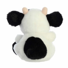 White and black cow plush from behind, black tail tuft and rounded legs