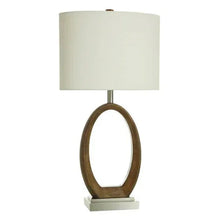 Table lamp with white fabric shade and dark wood-tone oval base