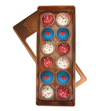 Assorted cake balls in a rectangular box, with red, white, and blue hearts.
