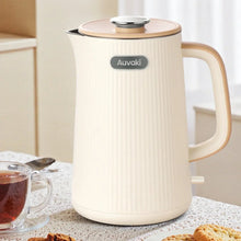Cream electric kettle with ridged body, lid, and side handle
