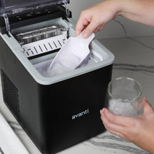 Black ice maker with open lid showing ice tray and scoop holder