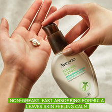 Aveeno facial moisturizer bottle dispensing cream into an open hand