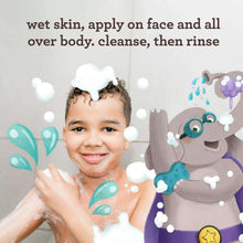 Aveeno Kids face & body wash bottle beside happy child with soap bubbles