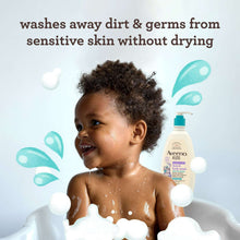 Aveeno Kids face & body wash bottle near smiling child with soap bubbles
