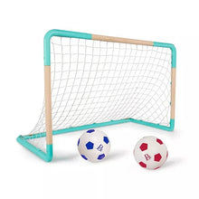 Mini soccer goal net with teal frame and two soccer balls on ground