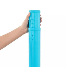 Blue tee-ball launcher cylinder held in a hand